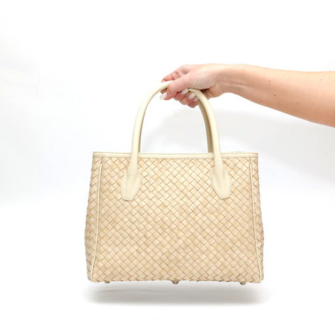 Borsa Grace in pelle intrecciata beige, realizzata a mano con cura artigianale. Accessori argentati che aggiungono un tocco di eleganza, chiusura sicura e interno spazioso per il massimo della praticità.