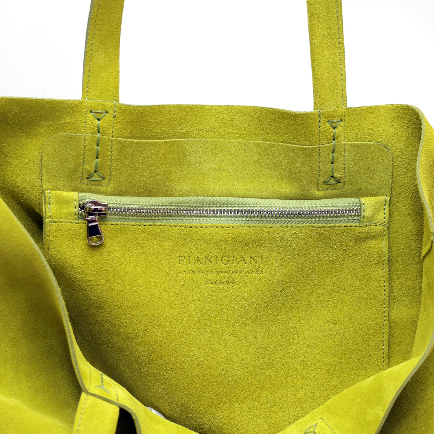 Soft 2.4 piccola, borsa da donna in pelle scamosciata lime, realizzata artigianalmente da Pianigiani Bags.
